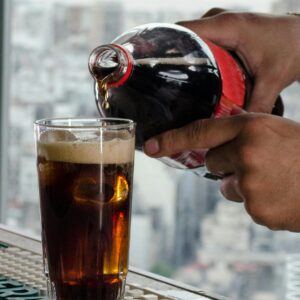 Refreshing cold beverage being poured into a glass with city skyline in Buenos Aires.